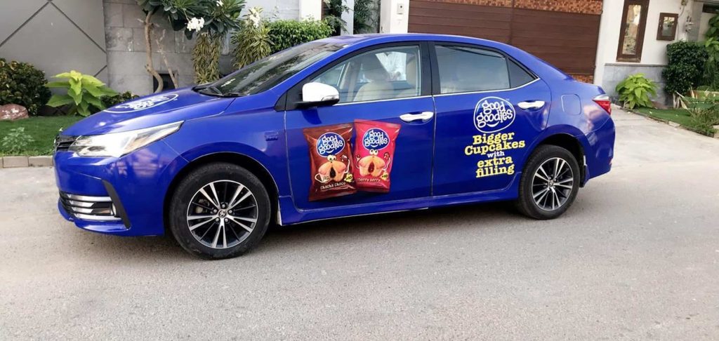 Car branding with cupcake advertisement wrap in Karachi for product promotion and outdoor vehicle marketing