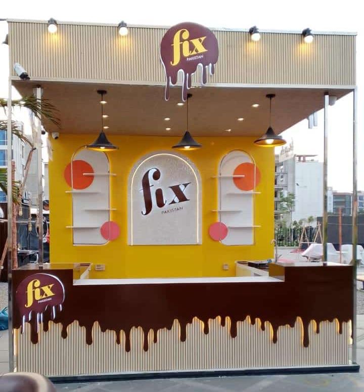 Side angle of Fix Pakistan food kiosk with chocolate branding