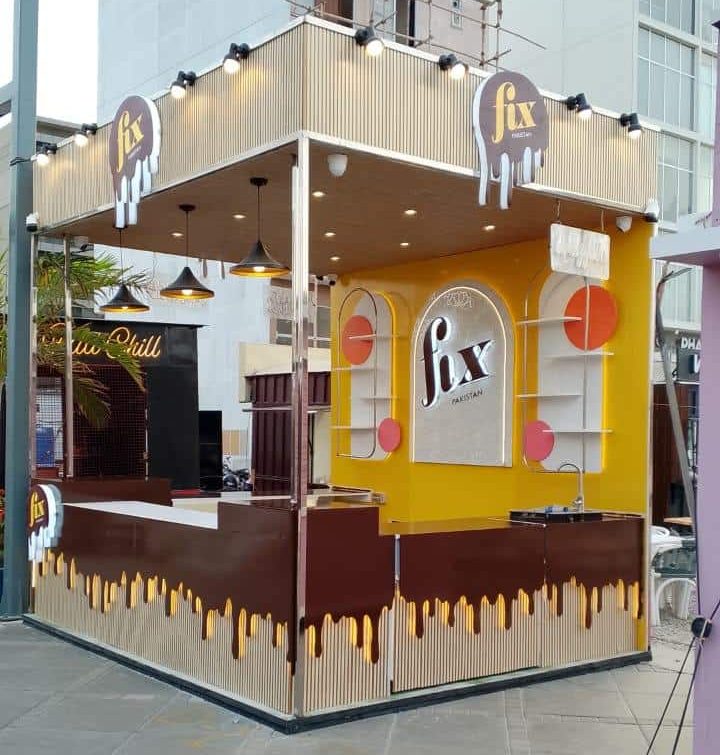Side angle of Fix Pakistan food kiosk with chocolate branding